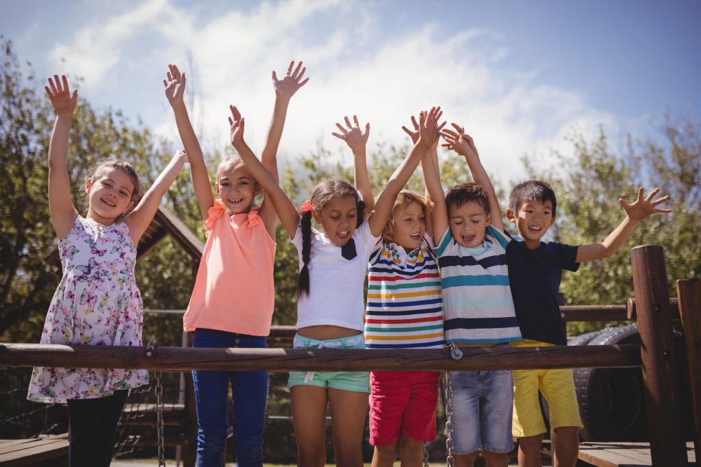 Happy schoolkids playing in playground